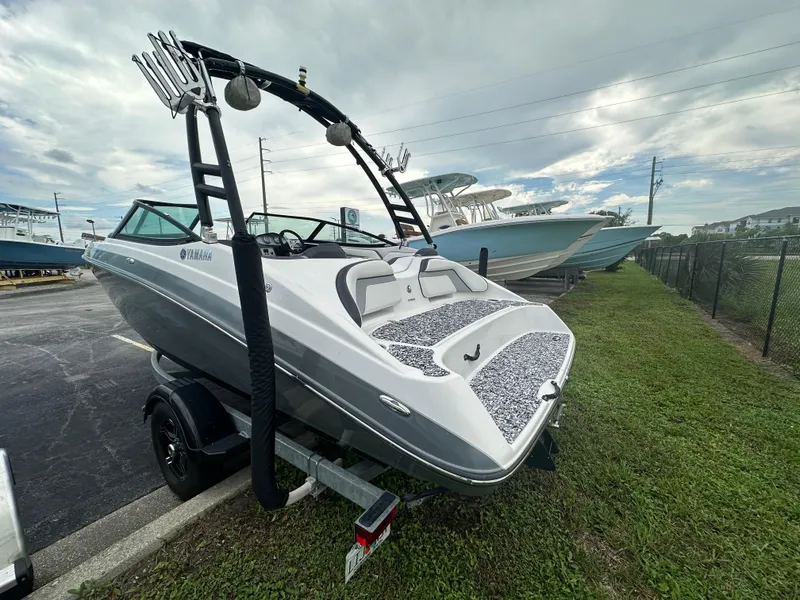 Slide: The Image of 2015 Yamaha SX192 boat on trailer, parked outdoors under cloudy sky. - 8