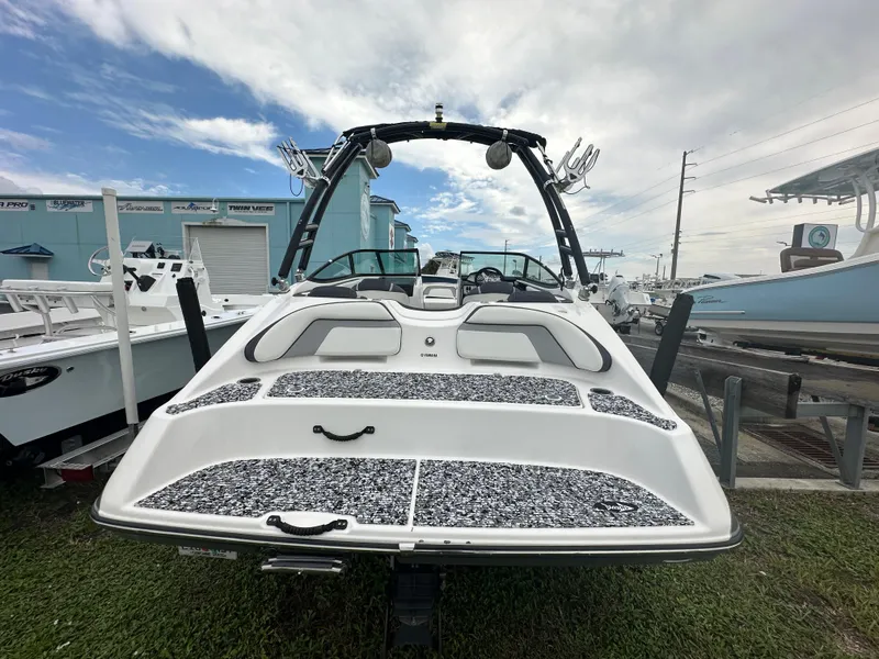 Slide: The Image of 2015 Yamaha Boats SX192, sleek design, docked outdoors under cloudy sky. - 9
