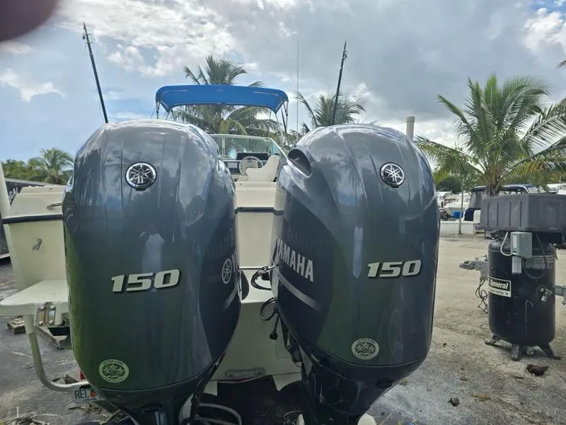 Slide: The Image of 1988 Grady-White 232 Gulfstream with twin Yamaha 150 engines, parked outdoors. - 12