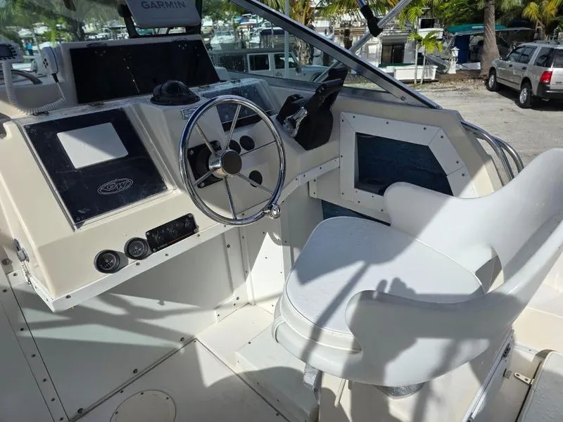 Slide: The Image of 1988 Grady-White 232 Gulfstream boat cockpit with steering wheel and control panel. - 3