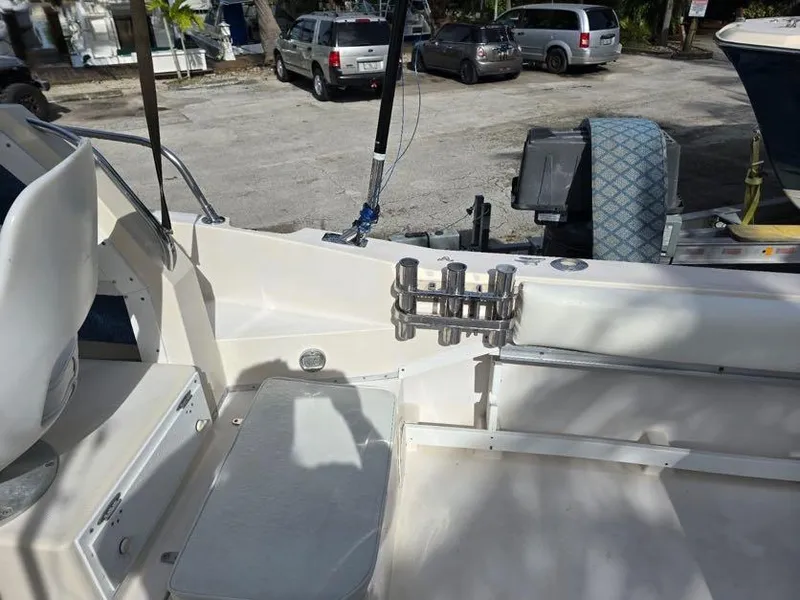Slide: The Image of 1988 Grady-White 232 Gulfstream boat interior with rod holders and seating. - 8
