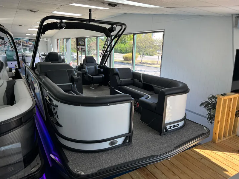 Slide: The Image of 2025 Crest Caribbean LX 230 SLRC pontoon boat interior with sleek seating and modern design. - 2