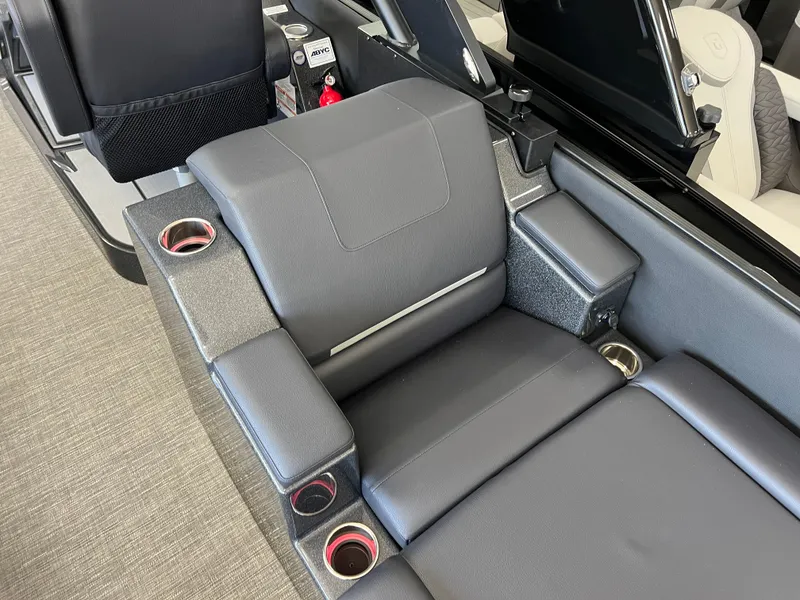 Slide: The Image of 2025 Crest Caribbean LX 230 SLRC boat interior with sleek seating and cup holders. - 22