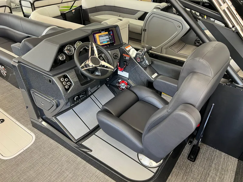 Slide: The Image of 2025 Crest Caribbean LX 230 SLRC boat interior with modern steering console and seating. - 26