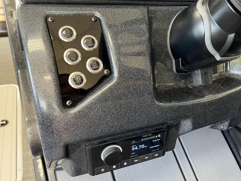 Slide: The Image of Control panel of 2025 Crest Caribbean LX 230 SLRC boat with gauges and radio. - 30