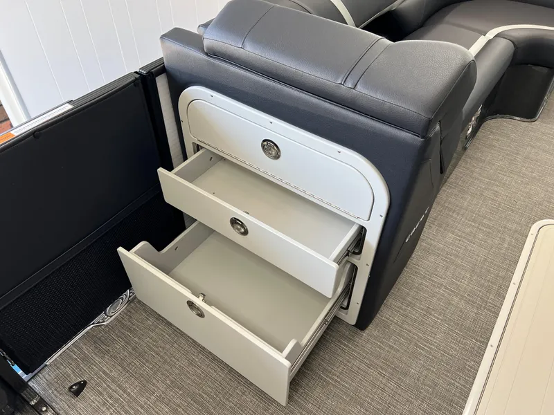 Slide: The Image of 2025 Crest Caribbean LX 230 SLRC interior with open storage drawers. - 31