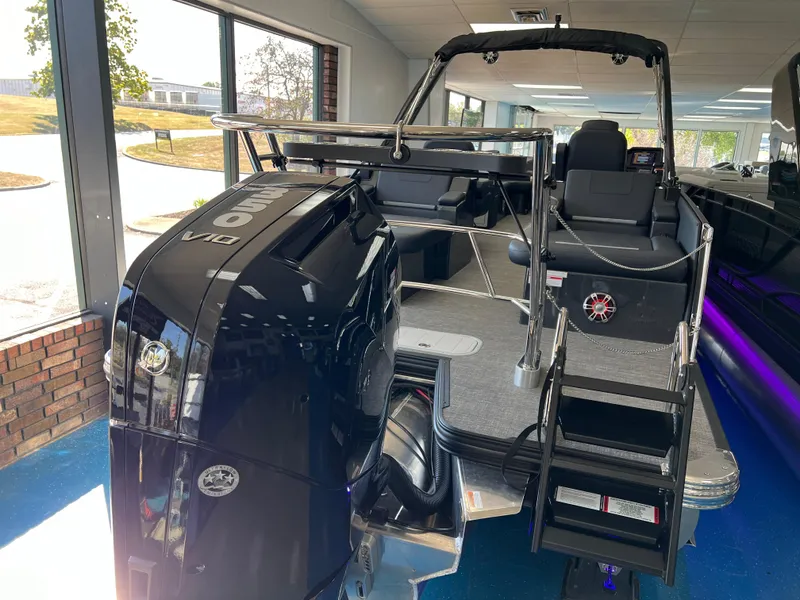 Slide: The Image of 2025 Crest Caribbean LX 230 SLRC boat with powerful engine in showroom. - 7