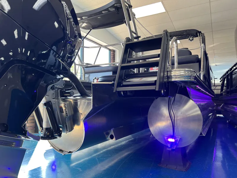 Slide: The Image of 2025 Crest Caribbean LX 230 SLRC pontoon boat with sleek design and blue LED lighting. - 8