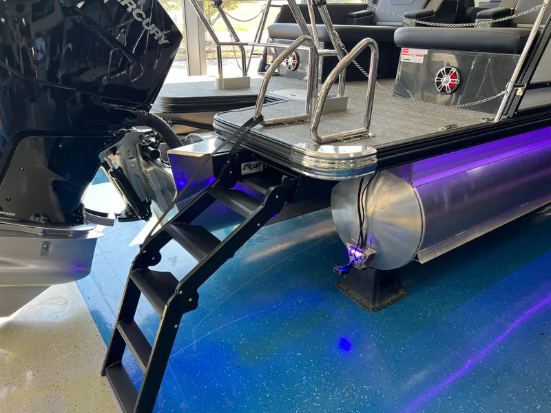 Slide: The Image of 2025 Crest Caribbean LX 230 SLRC pontoon boat with ladder and motor. - 9