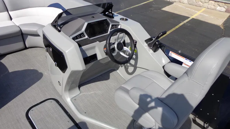 Slide: The Image of 2022 Manitou 23 SES Bench boat interior with steering console and seating. - 12