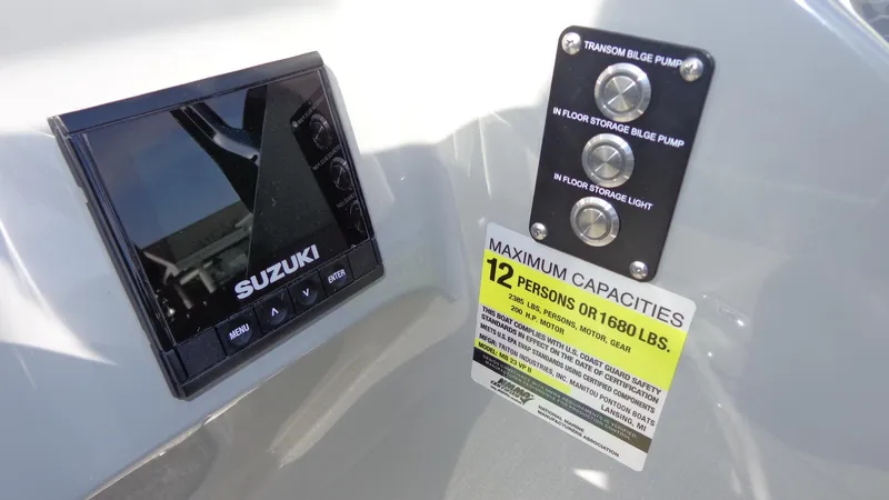 Slide: The Image of Suzuki control panel and capacity label on 2022 Manitou 23 SES Bench boat. - 13