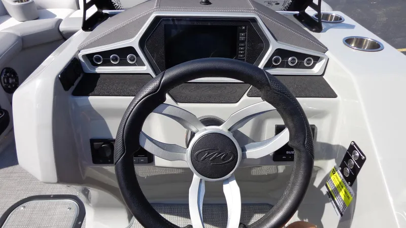Slide: The Image of Steering console of 2022 Manitou 23 SES Bench boat with modern dashboard design. - 14