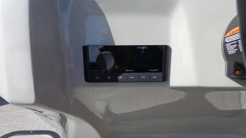 Slide: The Image of 2022 Manitou 23 SES Bench boat dashboard with Fusion audio system. - 16