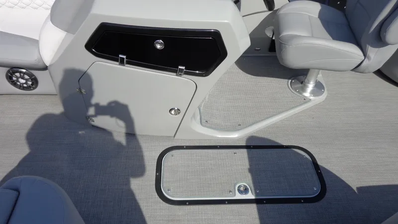 Slide: The Image of Interior of 2022 Manitou 23 SES Bench boat with seating and storage compartments. - 18