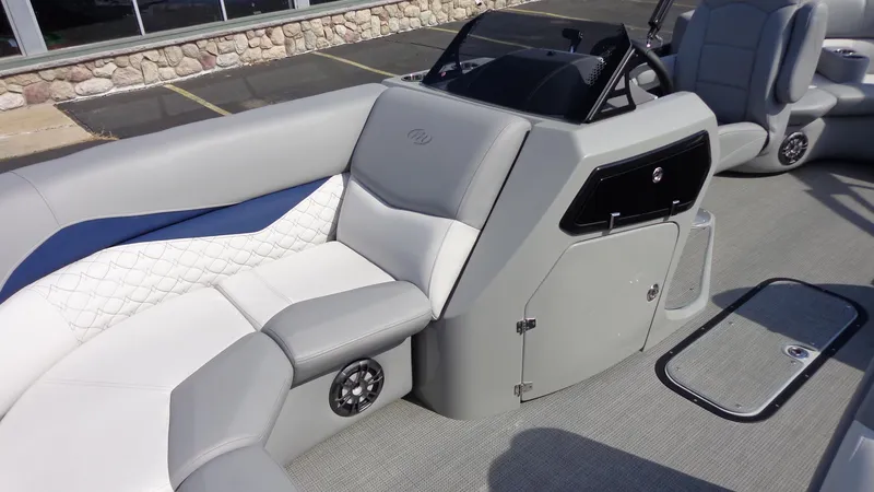 Slide: The Image of 2022 Manitou 23 SES Bench boat interior with gray and white seating. - 19