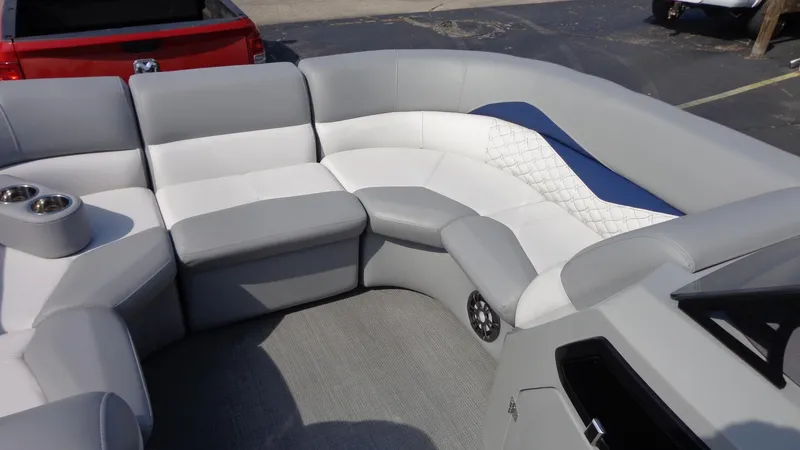 Slide: The Image of 2022 Manitou 23 SES Bench boat interior with gray and white seating. - 20