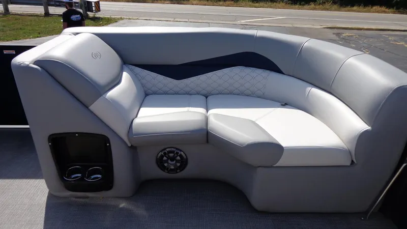 Slide: The Image of 2022 Manitou 23 SES Bench with gray cushioned seating and built-in cup holders. - 22