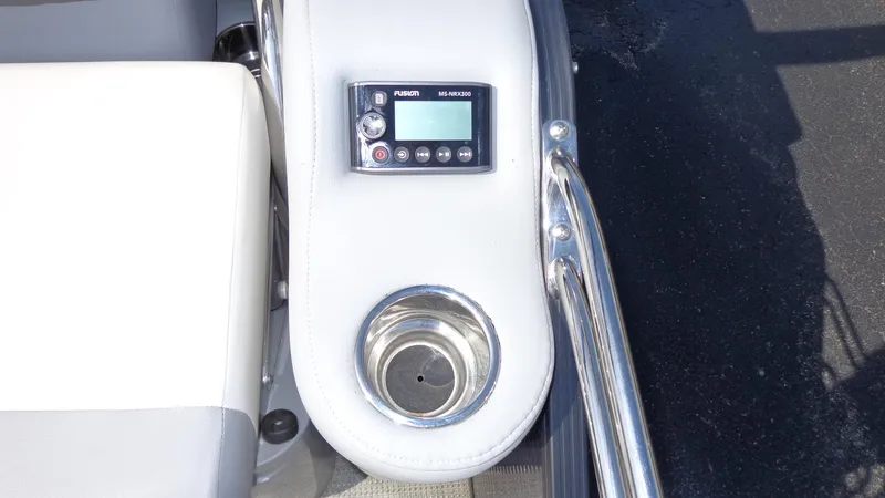 Slide: The Image of 2022 Manitou 23 SES Bench boat console with cup holder and control panel. - 5