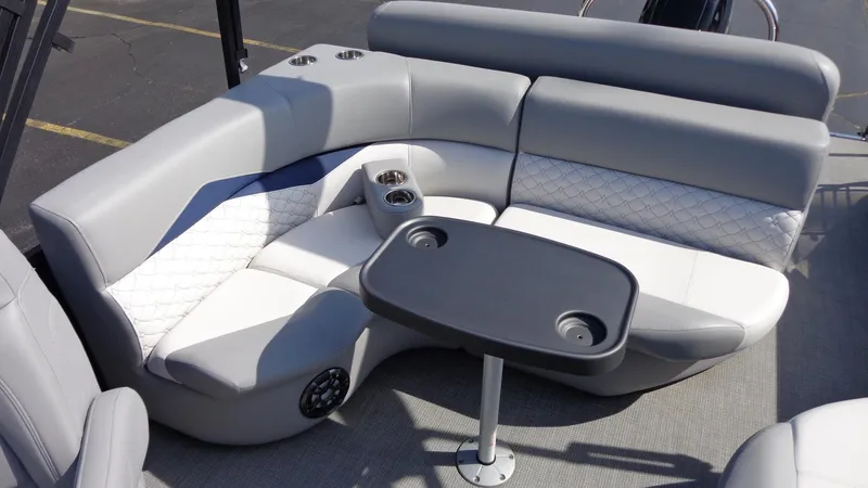 Slide: The Image of 2022 Manitou 23 SES Bench with gray seating and table, featuring cup holders. - 9