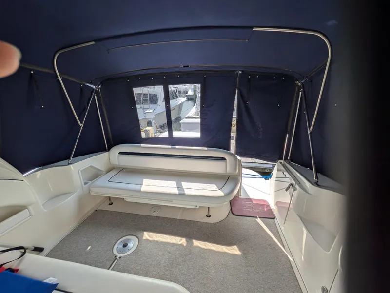 Slide: The Image of 2004 Sea Ray 360 Sundancer interior with blue canopy and seating area. - 11