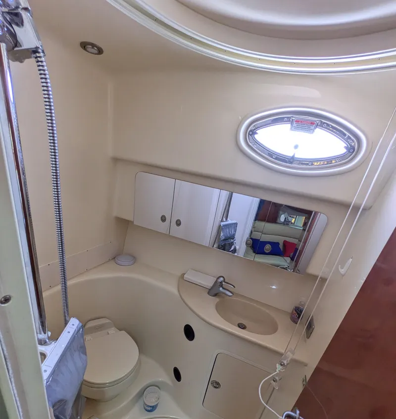 Slide: The Image of 2004 Sea Ray 360 Sundancer bathroom with shower, sink, and oval window. - 17