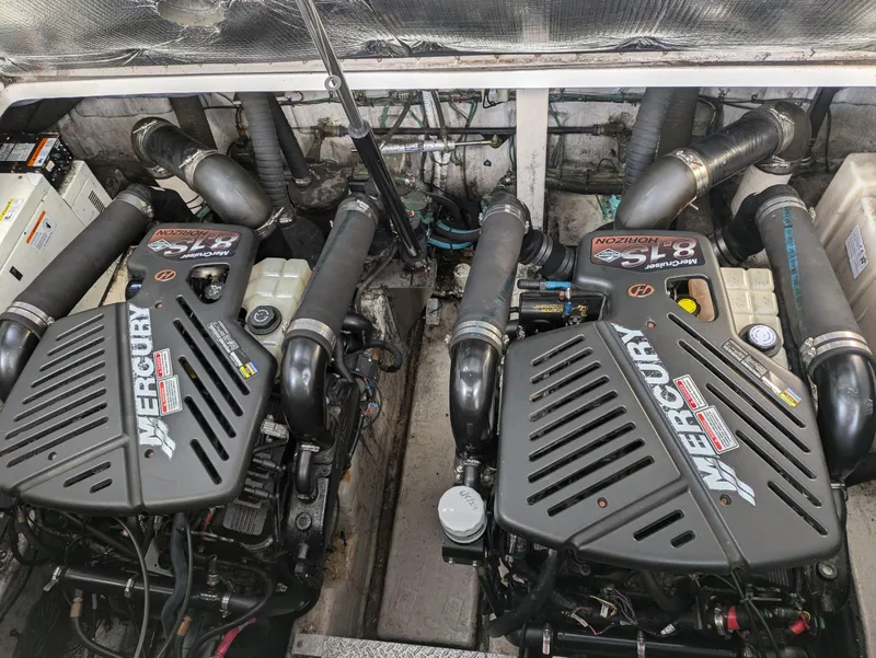 Slide: The Image of Twin Mercury engines in a 2004 Sea Ray 360 Sundancer boat engine compartment. - 18