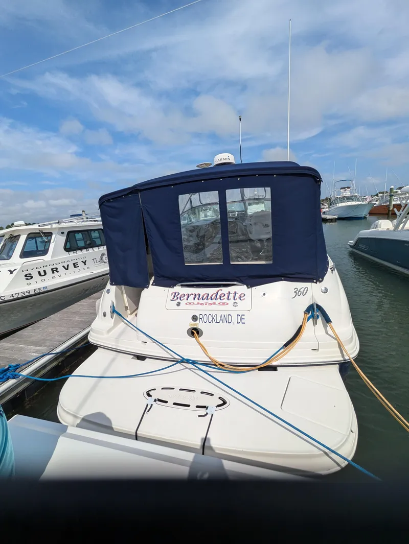 Slide: The Image of 2004 Sea Ray 360 Sundancer docked at marina under blue sky. - 4