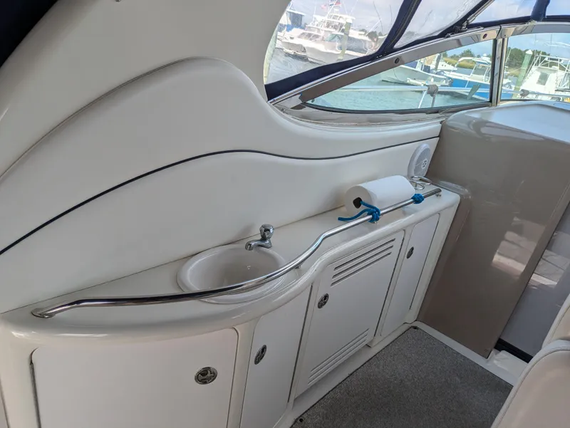 Slide: The Image of 2004 Sea Ray 360 Sundancer yacht interior with sink and storage cabinets. - 9
