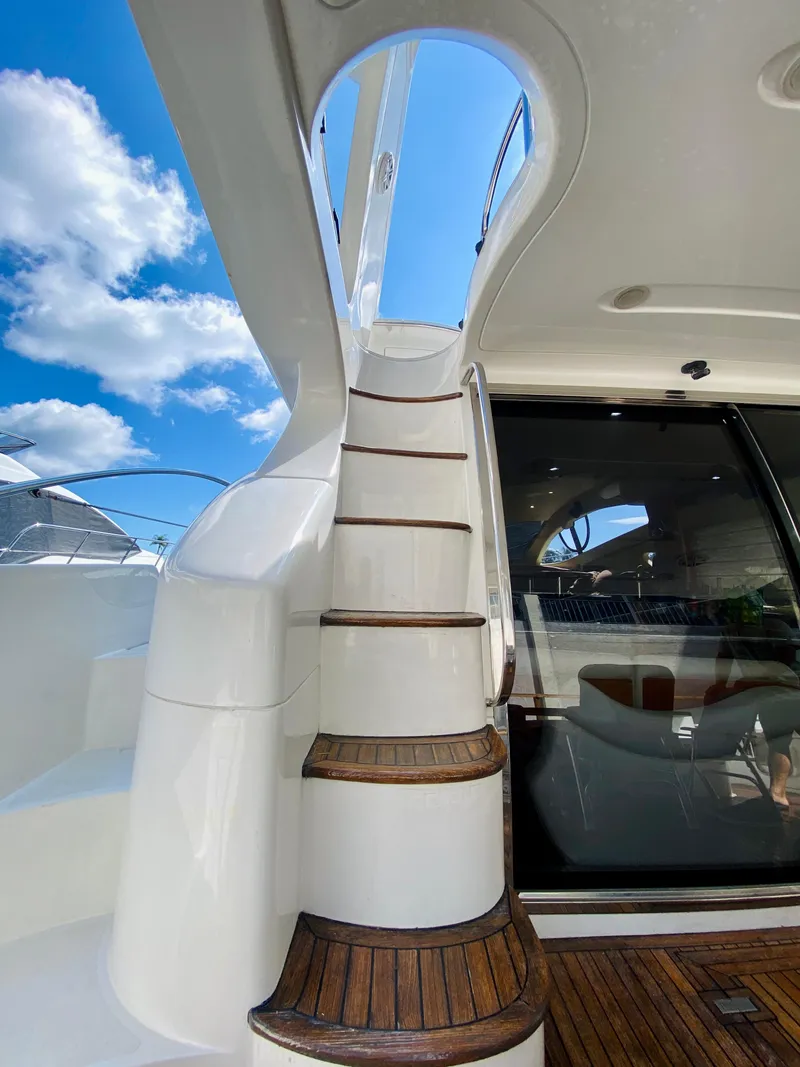 Slide: The Image of Staircase on 2002 Azimut 55 yacht with wooden steps and sleek design. - 17