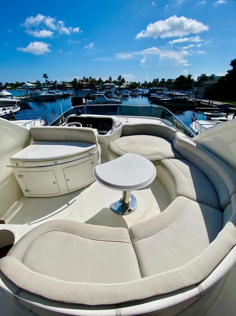 Slide: The Image of Luxurious 2002 Azimut 55 yacht with spacious seating and scenic marina view. - 20