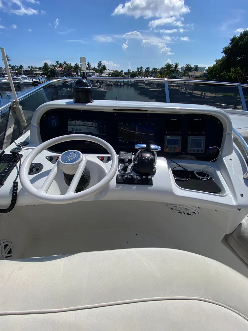 Slide: The Image of Helm of 2002 Azimut 55 yacht with steering wheel and navigation controls. - 24