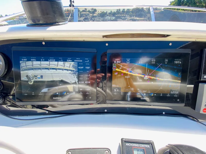 Slide: The Image of Azimut 55 yacht dashboard with dual Garmin navigation screens, 2002 model. - 25