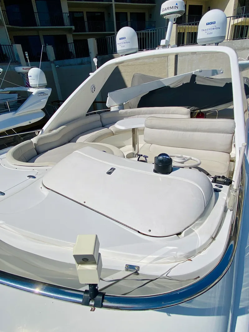 Slide: The Image of 2002 Azimut 55 yacht with sleek white deck and modern seating. - 26