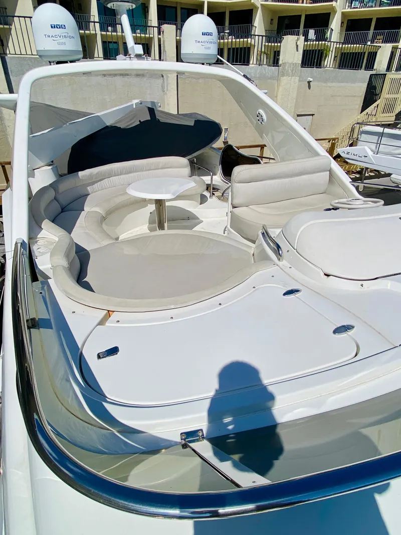 Slide: The Image of 2002 Azimut 55 yacht with spacious outdoor seating and table. - 27