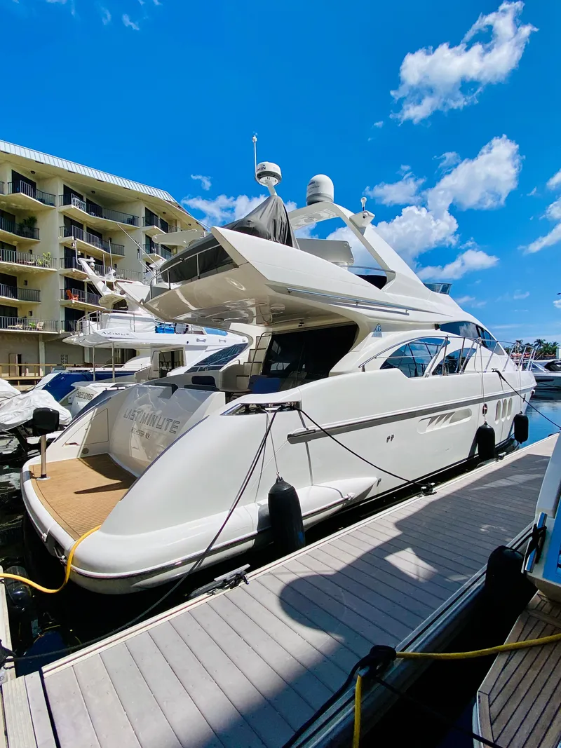 Slide: The Image of 2002 Azimut 55 yacht docked at marina under blue sky. - 3