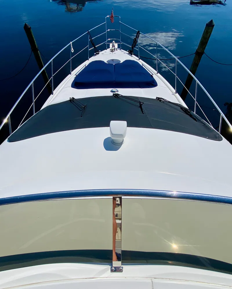 Slide: The Image of Azimut 55 yacht, 2002 model, docked on calm water, viewed from the bow. - 31