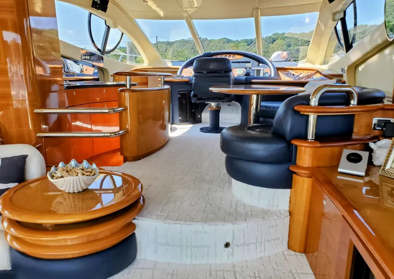 Slide: The Image of Luxurious interior of a 2002 Azimut 55 yacht with elegant wood finishes and plush seating. - 40