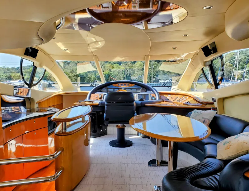 Slide: The Image of Luxurious interior of a 2002 Azimut 55 yacht with elegant seating and modern helm. - 43