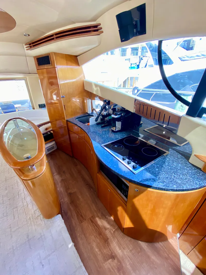 Slide: The Image of Luxurious 2002 Azimut 55 yacht kitchen with modern appliances and sleek wood finishes. - 45