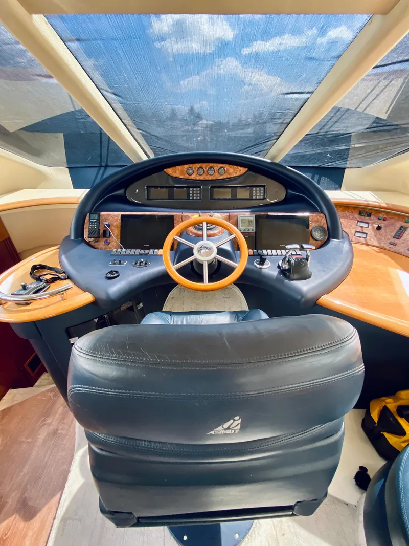 Slide: The Image of Cockpit of 2002 Azimut 55 yacht with leather seating and wooden steering wheel. - 47