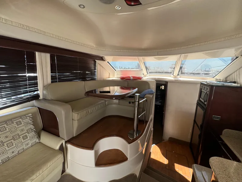 Slide: The Image of Luxurious interior of 2008 Sea Ray 44 Sedan Bridge yacht with elegant seating and panoramic windows. - 13