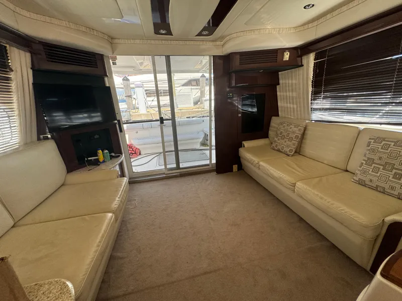 Slide: The Image of Luxurious interior of 2008 Sea Ray 44 Sedan Bridge yacht with beige sofas and modern decor. - 14