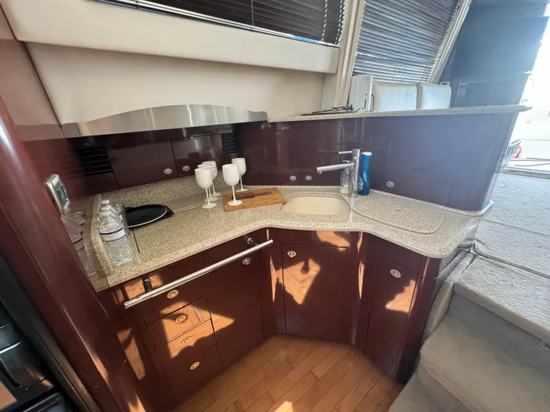 Slide: The Image of 2008 Sea Ray 44 Sedan Bridge yacht kitchen with modern amenities and sleek design. - 15