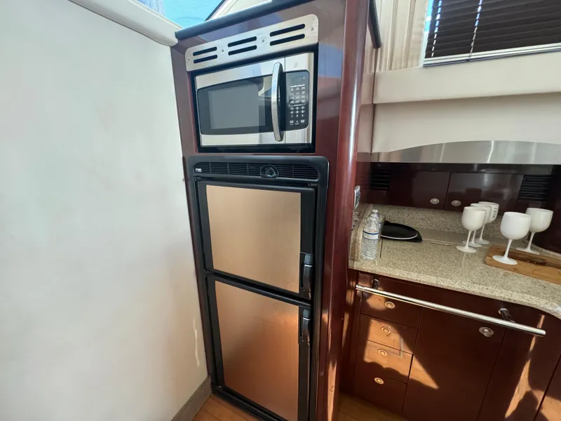 Slide: The Image of 2008 Sea Ray 44 Sedan Bridge yacht kitchen with microwave and fridge. - 16