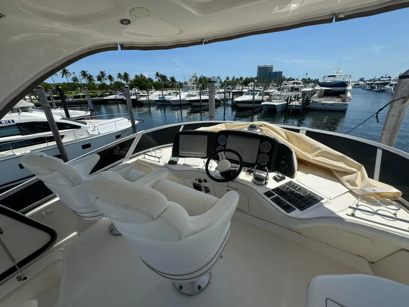 Slide: The Image of 2008 Sea Ray 44 Sedan Bridge yacht helm with marina view. - 22