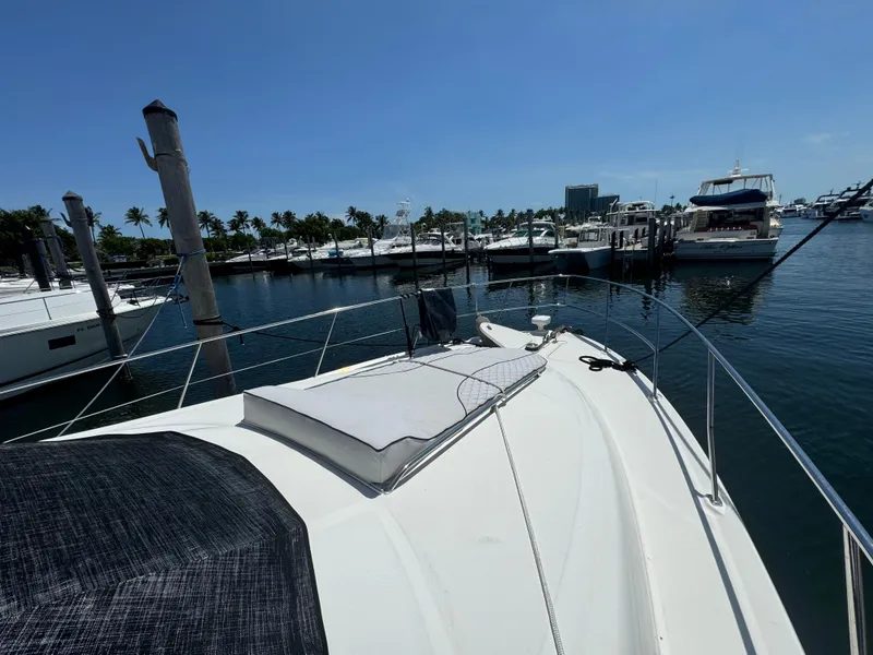 Slide: The Image of 2008 Sea Ray 44 Sedan Bridge yacht docked at marina under clear blue sky. - 25