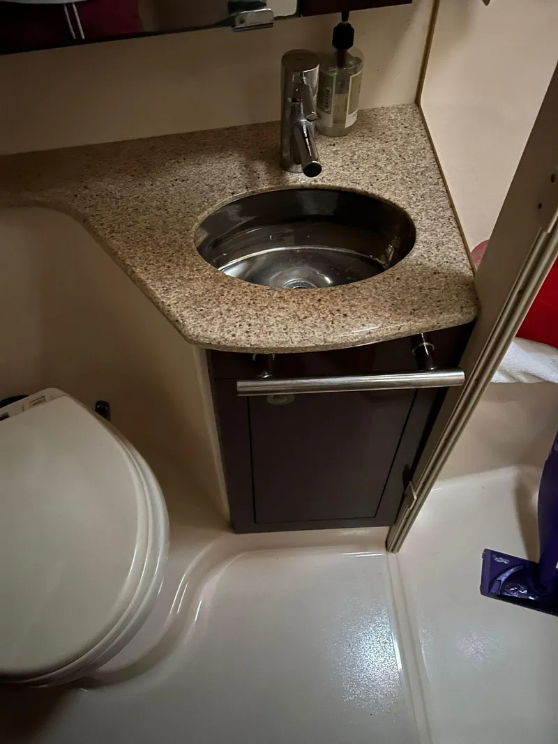 Slide: The Image of 2008 Sea Ray 44 Sedan Bridge bathroom with granite countertop and stainless steel sink. - 28
