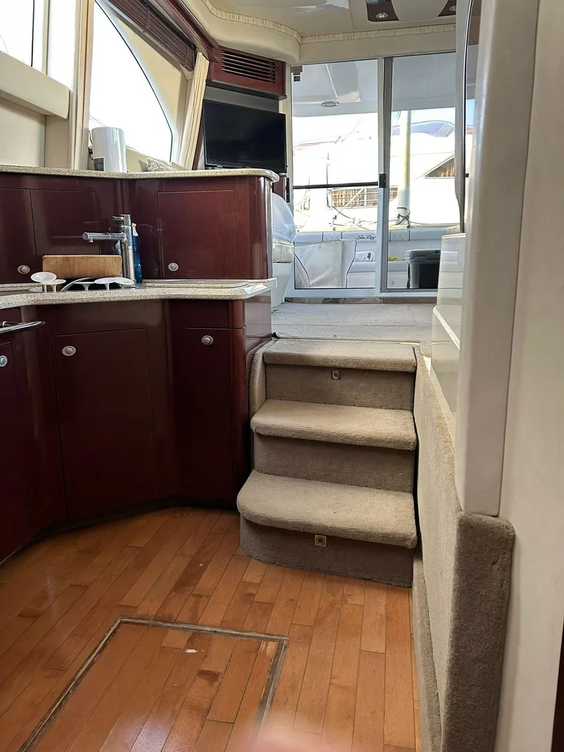 Slide: The Image of Interior of 2008 Sea Ray 44 Sedan Bridge with wooden flooring and carpeted stairs. - 31