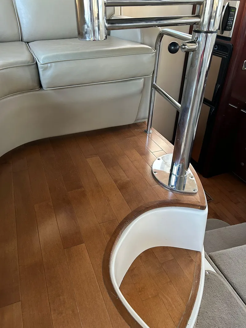 Slide: The Image of Interior of 2008 Sea Ray 44 Sedan Bridge with wooden flooring and seating. - 33