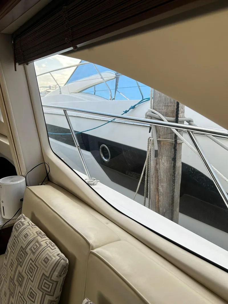 Slide: The Image of Interior view from 2008 Sea Ray 44 Sedan Bridge yacht, showing docked boat outside window. - 34